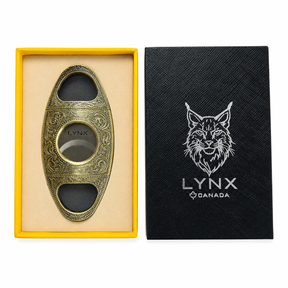 Cigar cutter with 'LYNX' branding on a black box and yellow tray